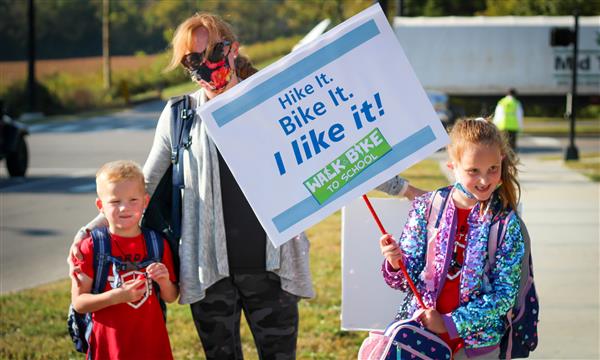 Family holds up Walk-to-School signs